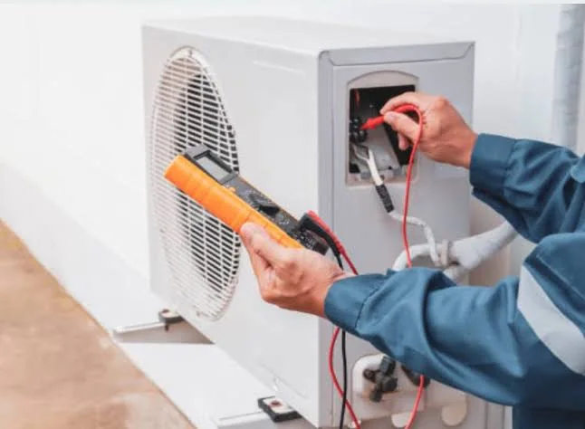 Technician inspecting residential HVAC equipment